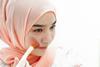 An image showing a girl applying makeup